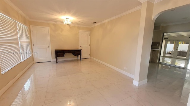 interior space featuring baseboards, arched walkways, marble finish floor, and ornamental molding