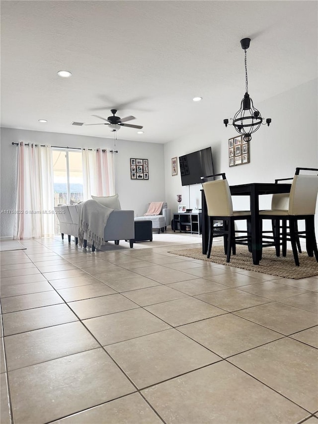 tiled dining area with ceiling fan with notable chandelier, recessed lighting, and visible vents