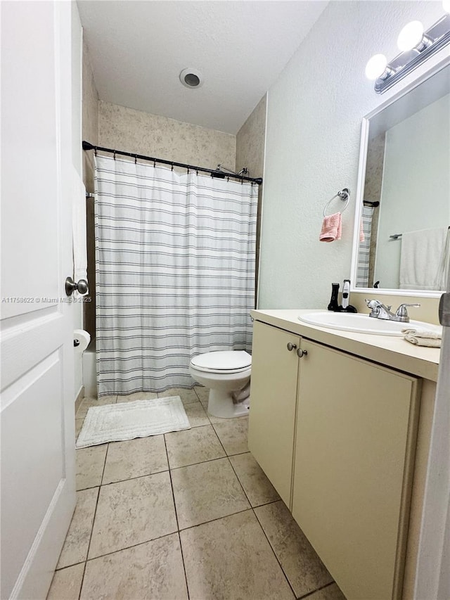 full bathroom featuring vanity, tile patterned floors, toilet, and a shower with curtain