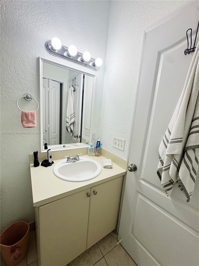 bathroom with vanity and a textured wall