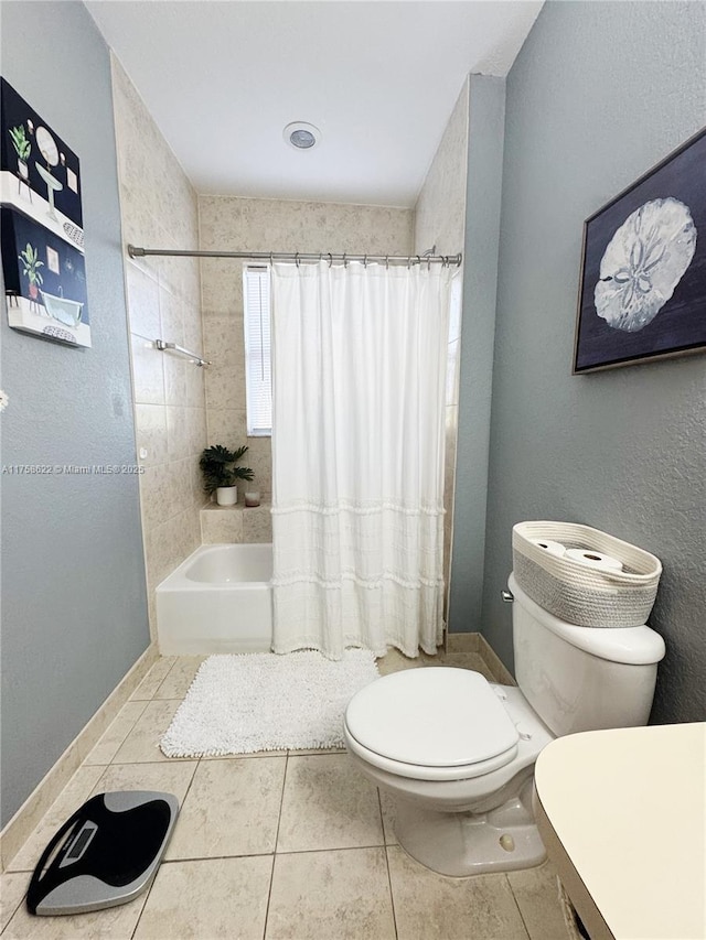 full bathroom with tile patterned floors, toilet, and shower / bath combo