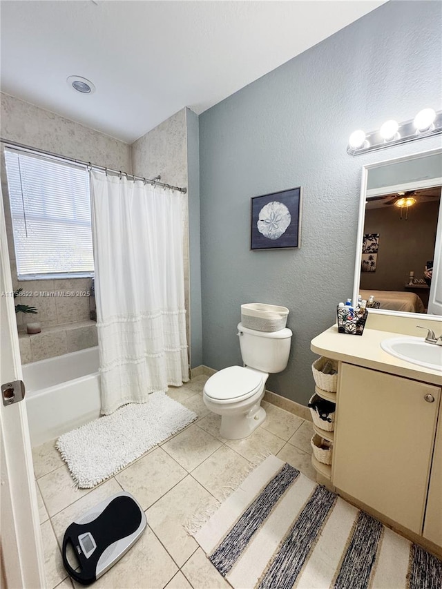 full bathroom featuring tile patterned flooring, baseboards, toilet, shower / bath combo, and vanity