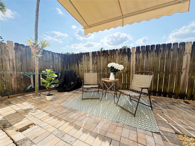 view of patio featuring fence