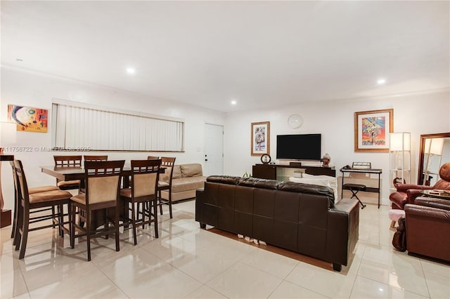 living room with recessed lighting and ornamental molding