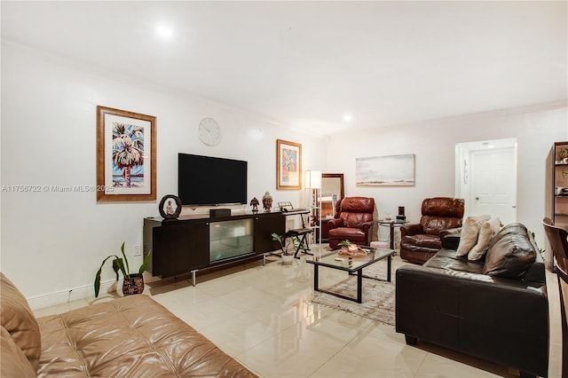 living area with light tile patterned floors, baseboards, and crown molding