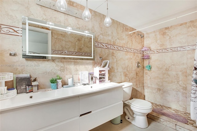 bathroom featuring vanity, tile walls, toilet, and a tile shower