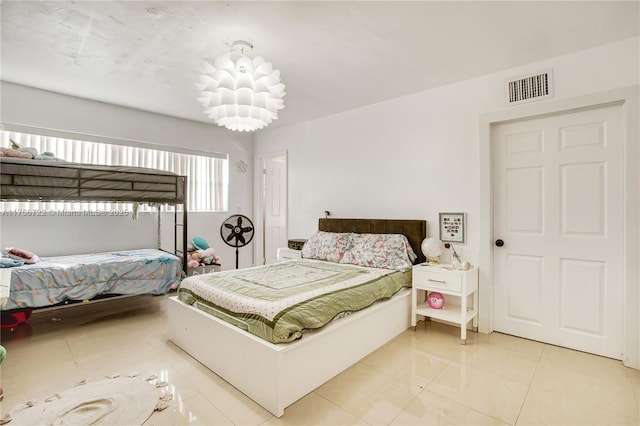 bedroom with tile patterned floors and visible vents