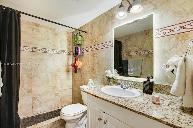 full bath with vanity, tile walls, toilet, and a tile shower