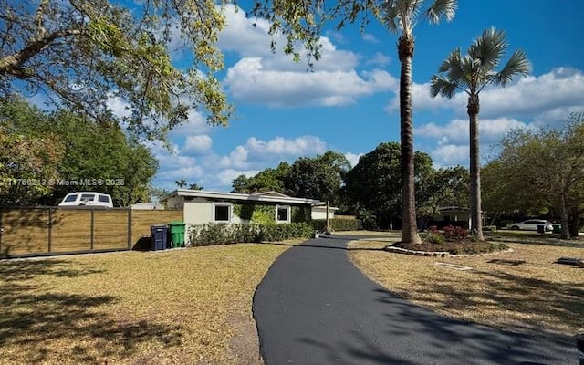 view of front of house with a front yard and fence