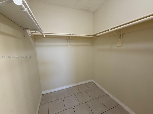 walk in closet with light tile patterned flooring