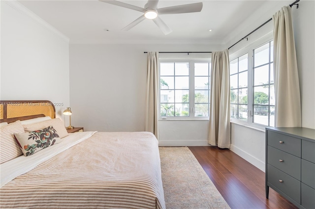 bedroom with baseboards, dark wood-style floors, a ceiling fan, and ornamental molding