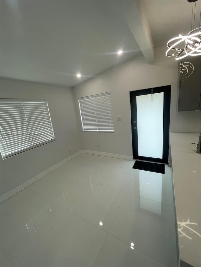 empty room with lofted ceiling with beams, light tile patterned floors, recessed lighting, and baseboards