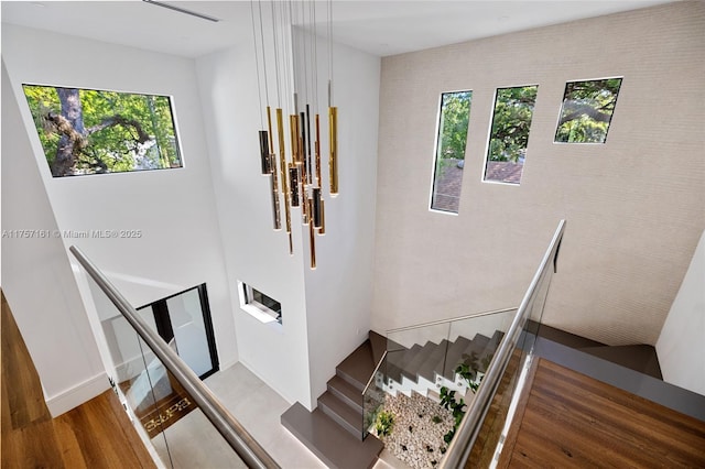 staircase featuring wood finished floors and a wealth of natural light