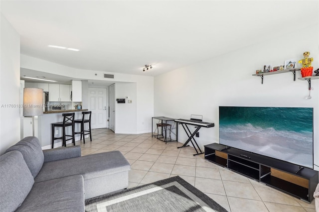 living room featuring visible vents and light tile patterned flooring