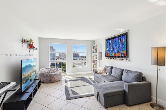 living room with light tile patterned floors and baseboards