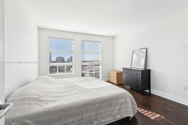 bedroom featuring baseboards and wood finished floors