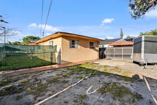 view of home's exterior featuring an outdoor structure and fence