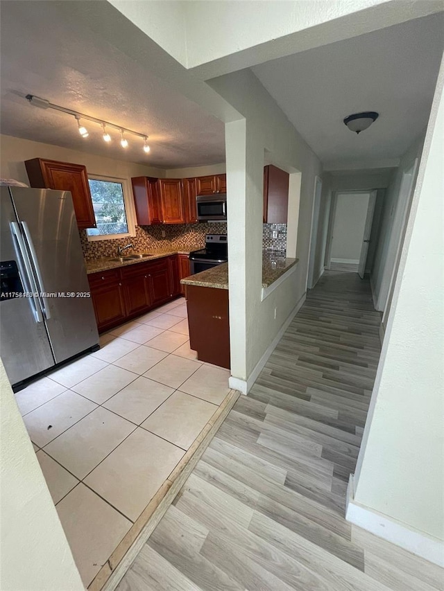 4896 SW 28th Ter, Dania Beach, FL 33312 - kitchen with decorative backsplash, baseboards, appliances with stainless steel finishes, and a sink
