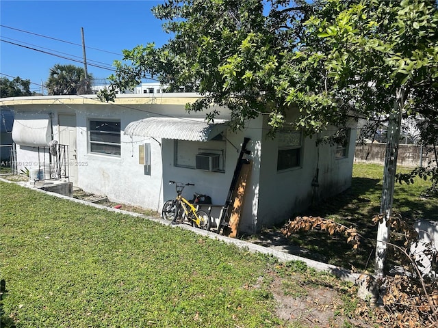 view of front of home with stucco siding and a front yard