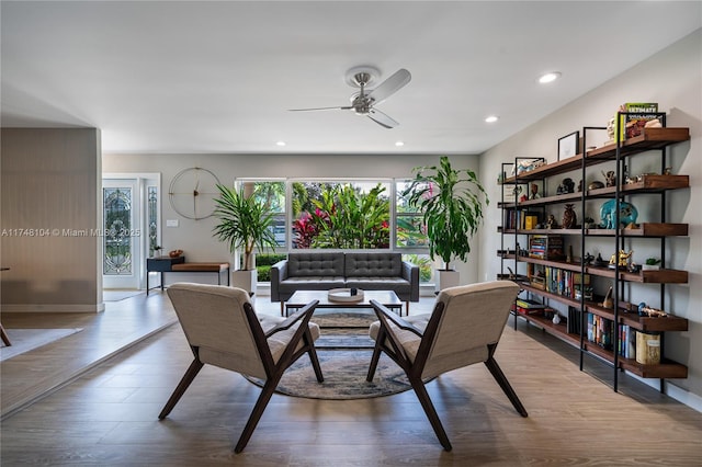 living area featuring recessed lighting, wood finished floors, baseboards, and ceiling fan