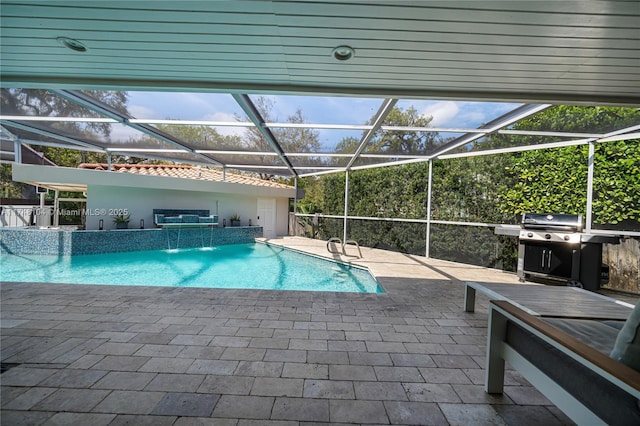 pool with a patio area, glass enclosure, and a grill