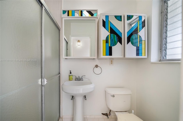 full bath featuring a shower stall and toilet