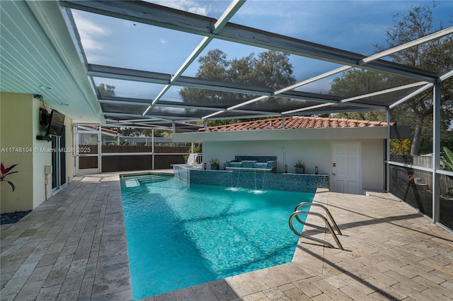 view of pool featuring a fenced in pool, glass enclosure, and a patio area