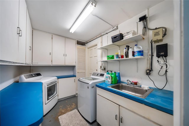 laundry room featuring independent washer and dryer, a sink, and cabinet space