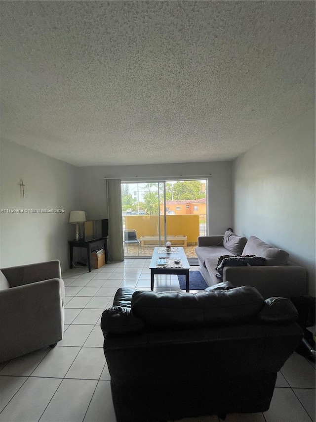 living room featuring light tile patterned floors and a textured ceiling