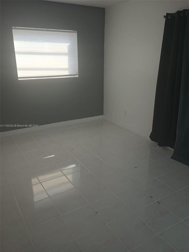 empty room with tile patterned floors