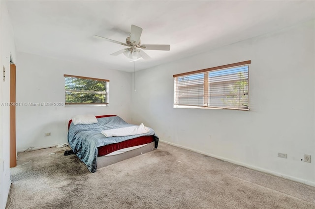 carpeted bedroom with baseboards and a ceiling fan