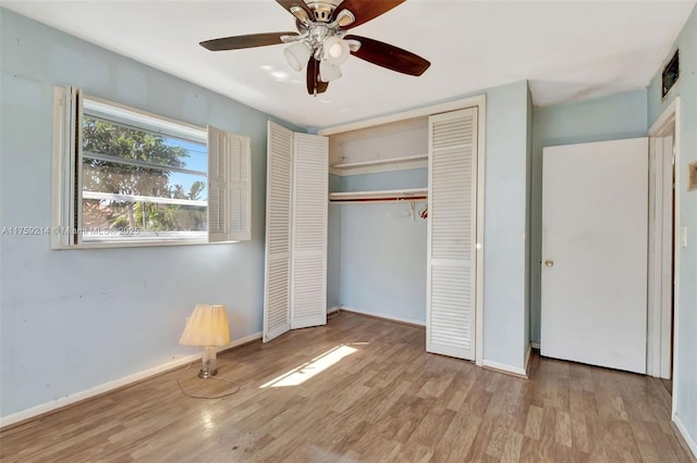 unfurnished bedroom featuring a ceiling fan, wood finished floors, a closet, and baseboards