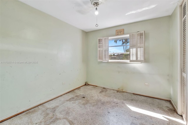 empty room featuring carpet and baseboards