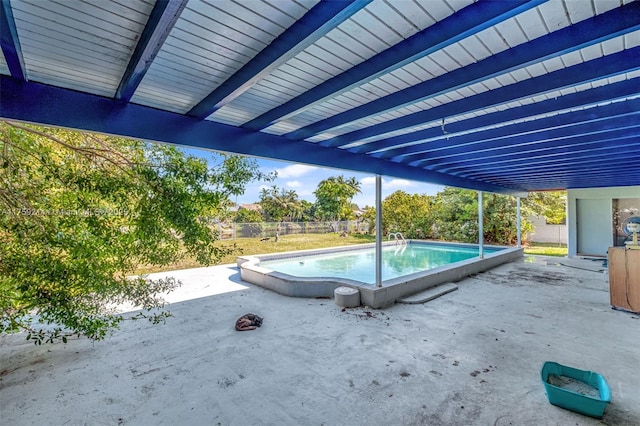 outdoor pool featuring a patio and fence