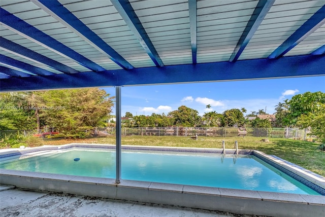 outdoor pool featuring a lawn and a fenced backyard