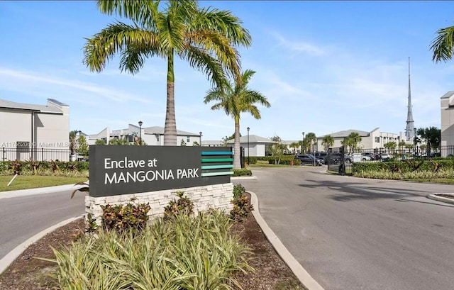 community sign featuring a residential view and fence