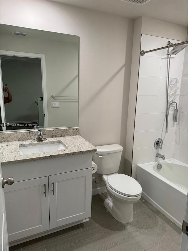 bathroom featuring tub / shower combination, visible vents, toilet, and vanity