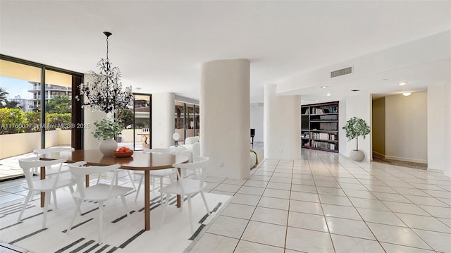 unfurnished dining area with light tile patterned flooring, visible vents, a notable chandelier, and expansive windows