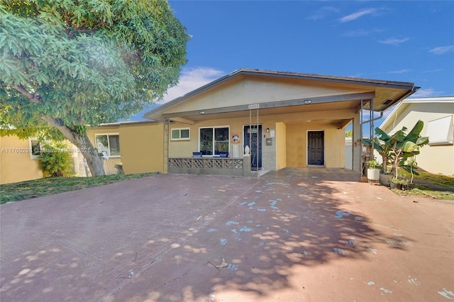 view of front of property featuring a porch and stucco siding