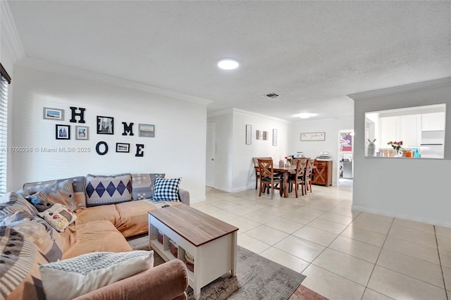 living area with visible vents, ornamental molding, a textured ceiling, light tile patterned flooring, and baseboards