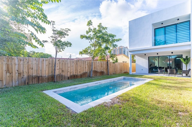 view of pool with a yard, a fenced in pool, a fenced backyard, and a patio area