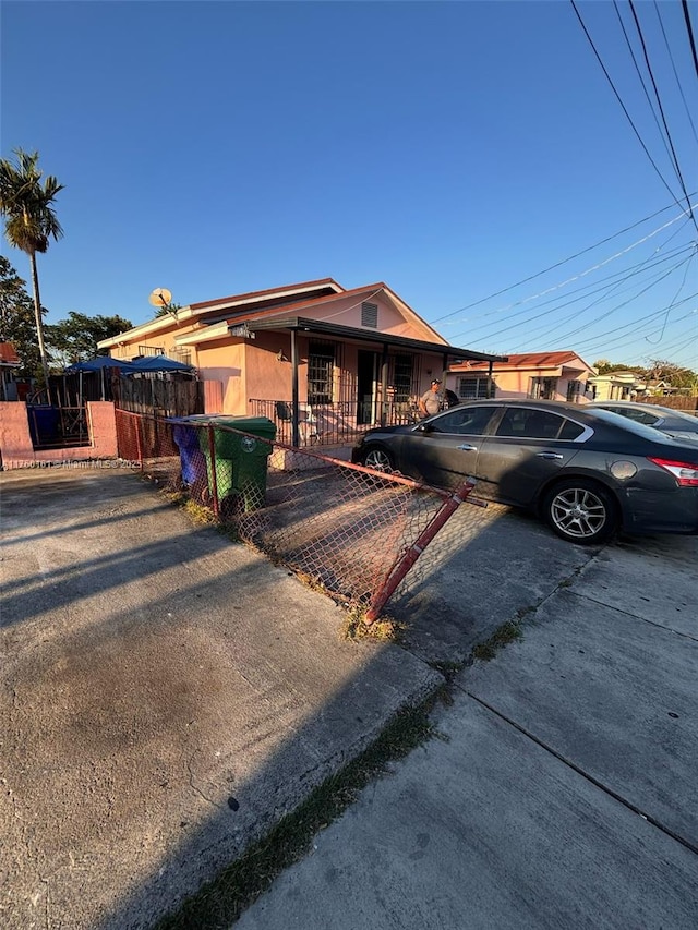 view of front of house with a fenced front yard and a gate