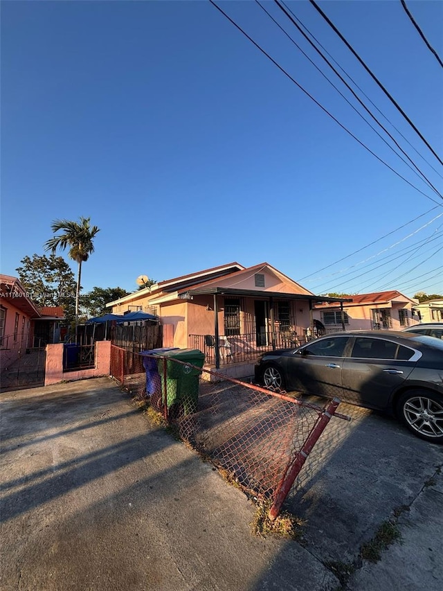 ranch-style house featuring a fenced front yard and a gate