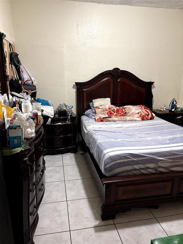 bedroom featuring light tile patterned floors