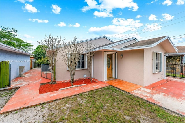 single story home featuring stucco siding, a patio, central AC, and fence