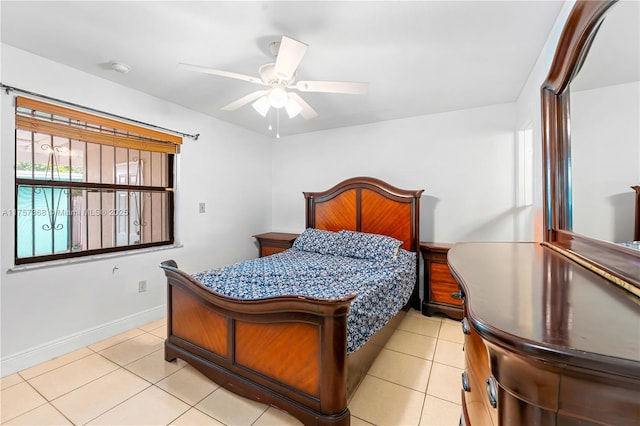 bedroom featuring light tile patterned flooring, a ceiling fan, and baseboards