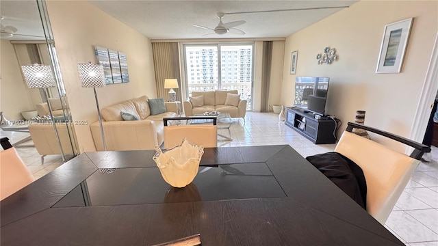 tiled dining room with a ceiling fan