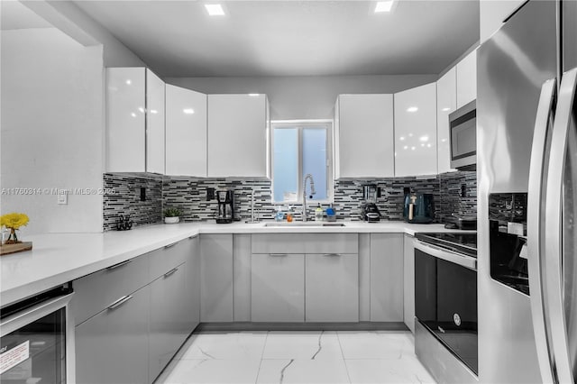 231 NW 44th St, Miami, FL 33127 - kitchen with appliances with stainless steel finishes, modern cabinets, beverage cooler, a sink, and white cabinets