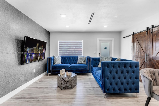 231 NW 44th St, Miami, FL 33127 - living area with a barn door and light wood-type flooring