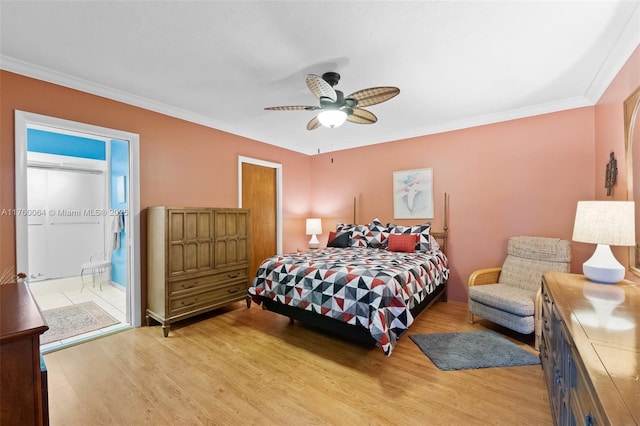 bedroom with ensuite bath, a ceiling fan, light wood-style floors, and ornamental molding